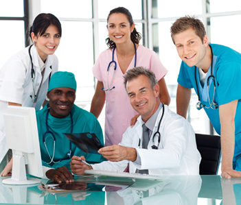 Group of doctors in a meeting looking at the camera